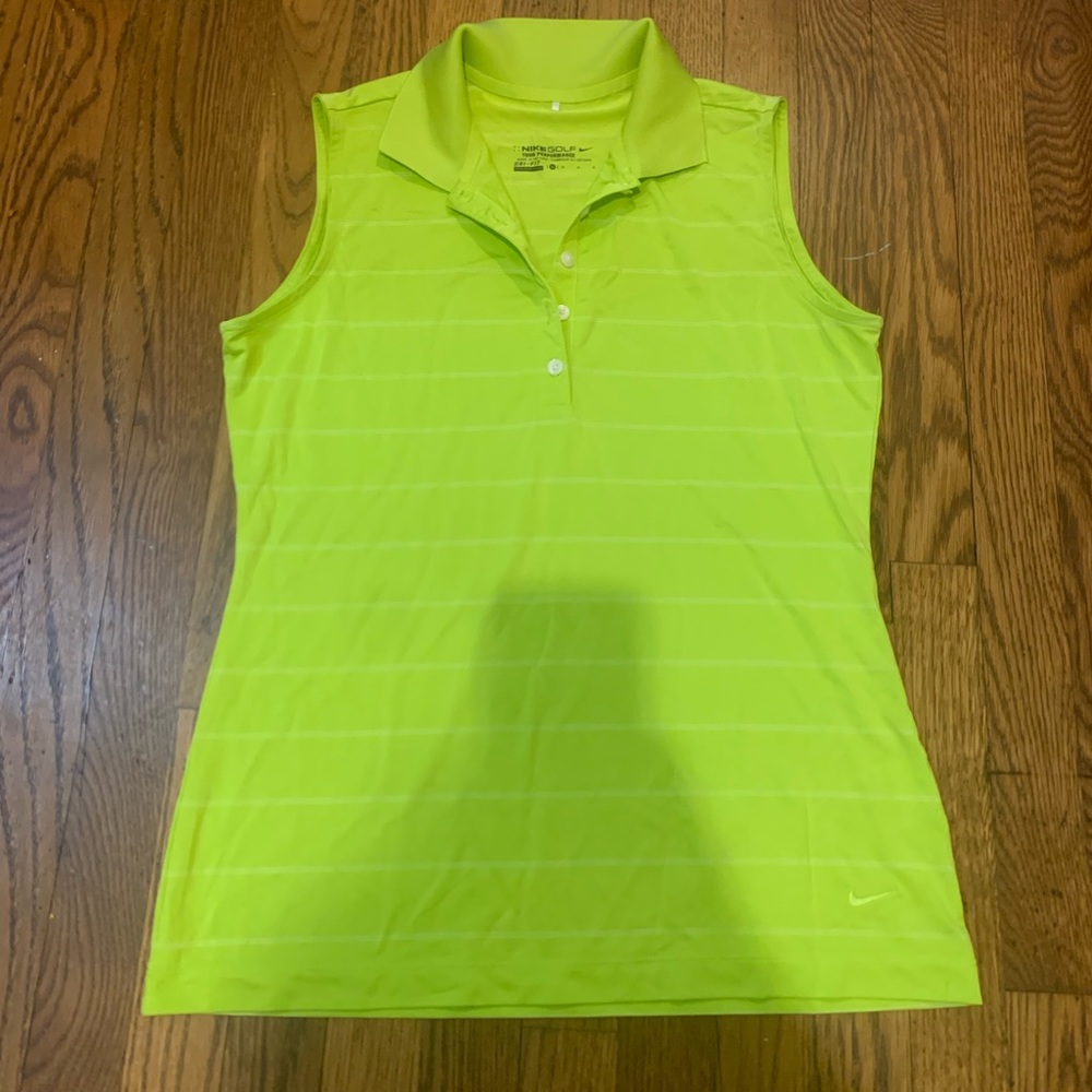 Look cute on the golf course in this line green Nike tour performance shirt.